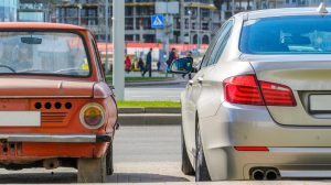 old car next to new car